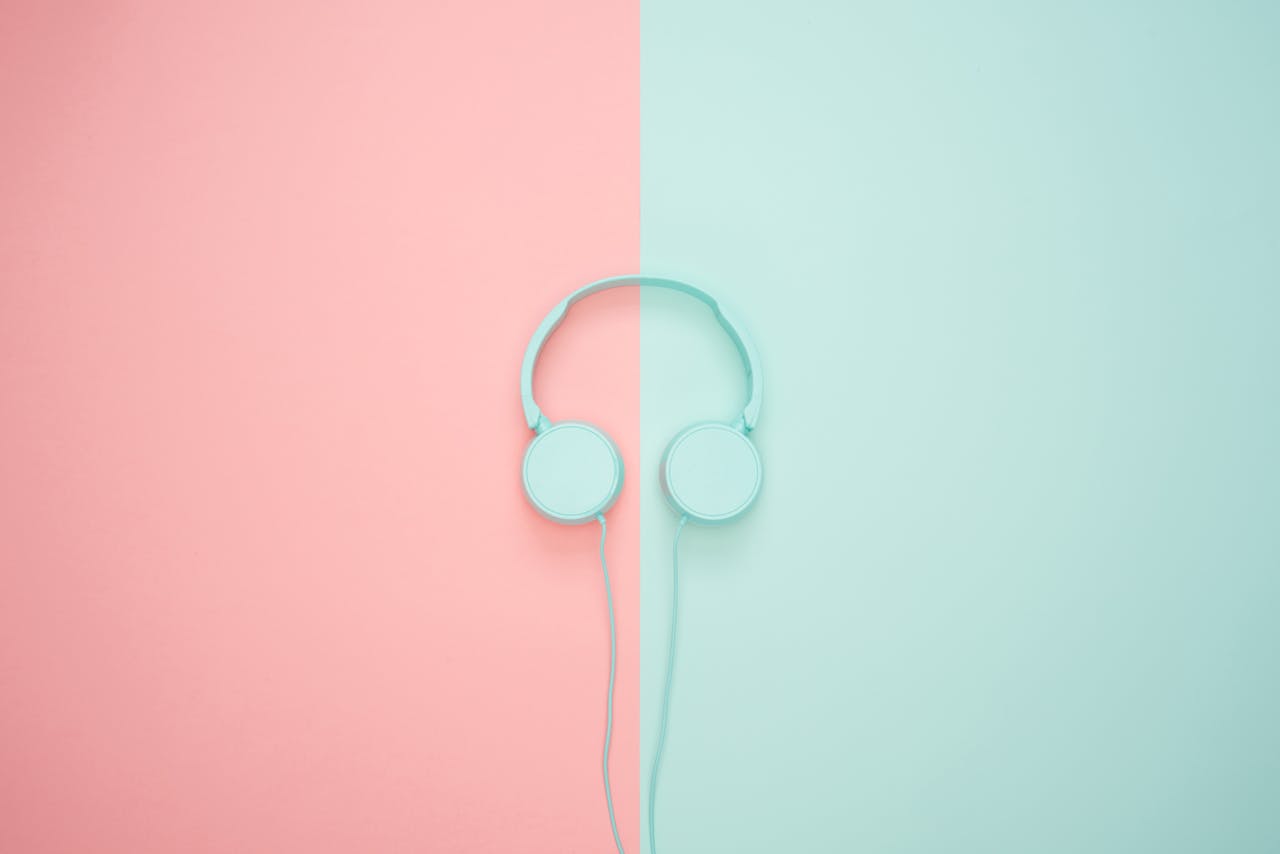 journey Minimalist headphones on a pink and mint background, artistic and modern.