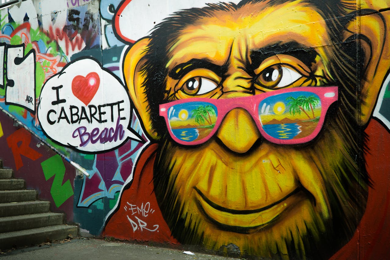 team-02 Colorful street art of a monkey with sunglasses on stairs, featuring Cabarete Beach text.